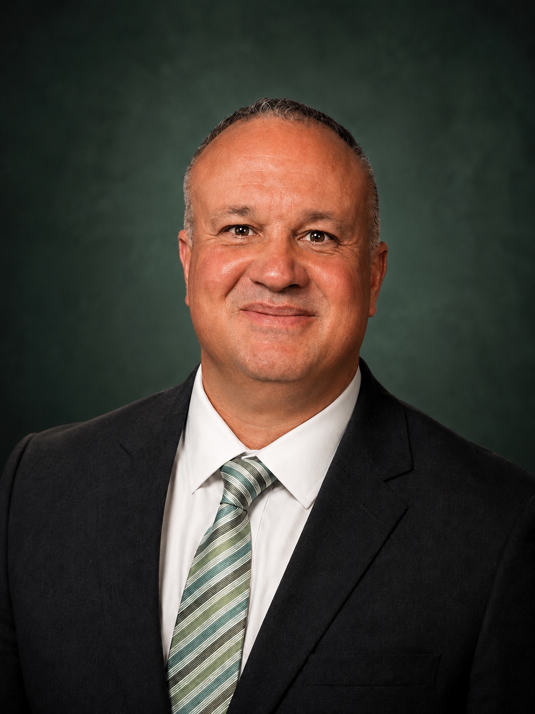 Terry Pittinger in a dark suit and green-striped tie